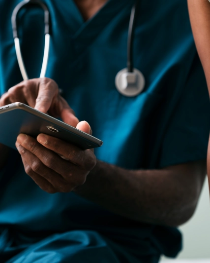 Healthcare professional shows patient information on device