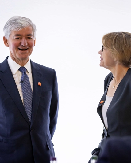GSK Chair, Jon Symonds listens to shareholder while CFO Julie Brown looks on