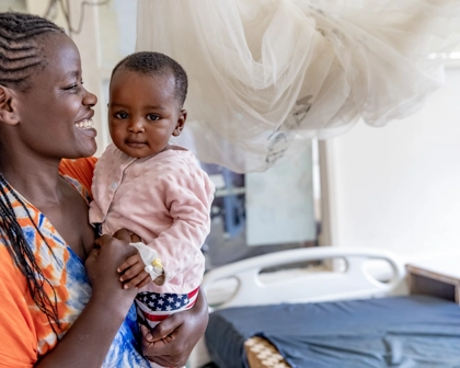 Mother holding her baby smiling