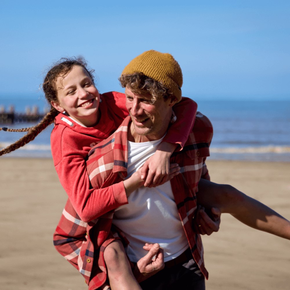 child riding on a parent's back