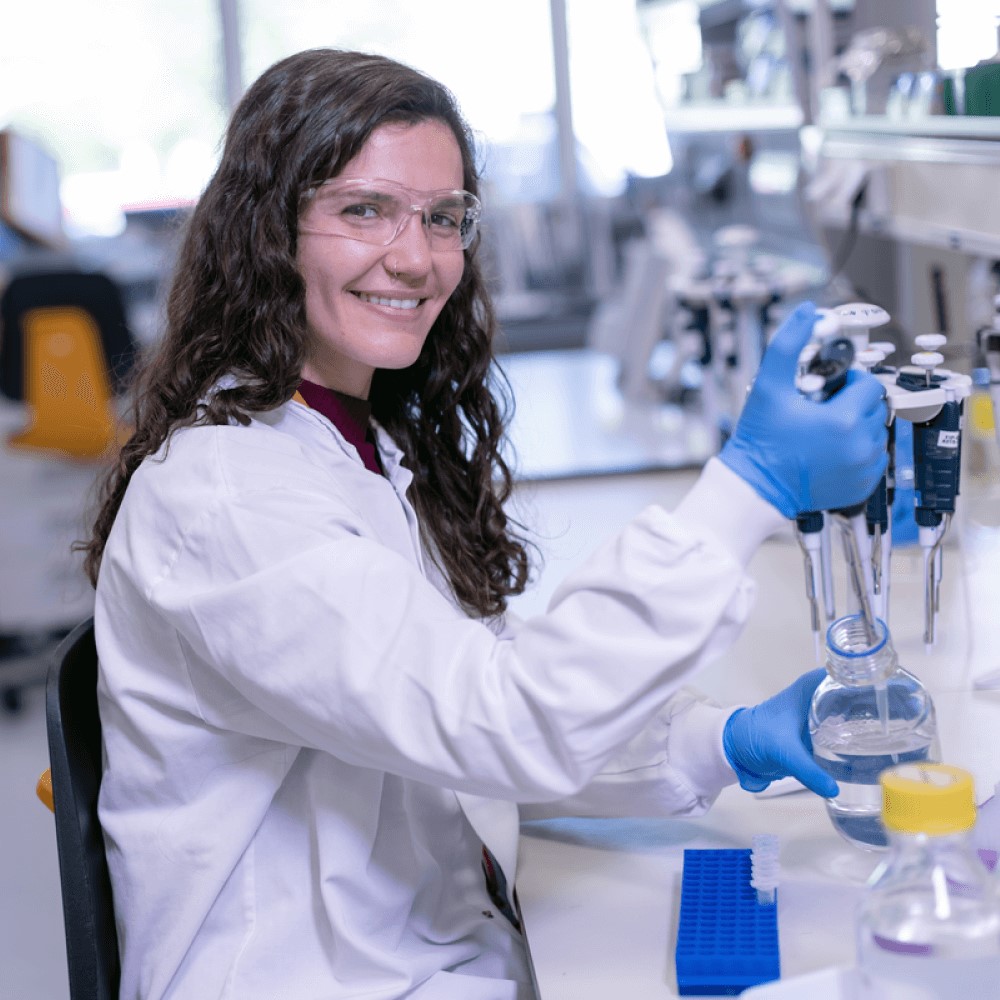 scientist in a lab using pipettes