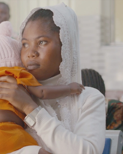 Mother carrying a baby