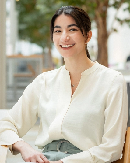 Woman sitting at a table and smiling