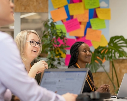 Employees smiling in a meeting