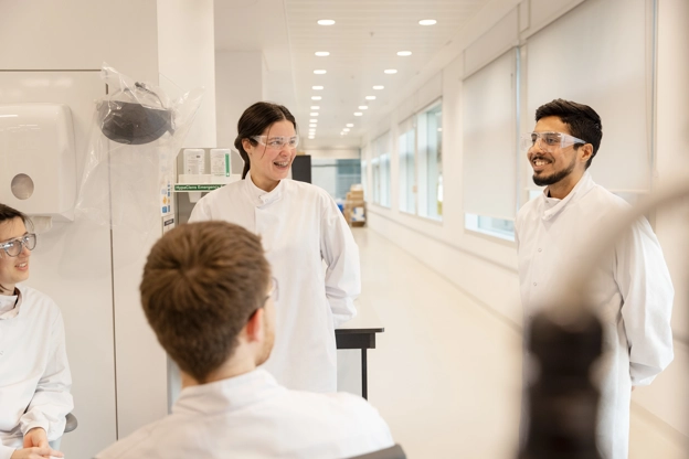 Scientists talking and laughing in a lab