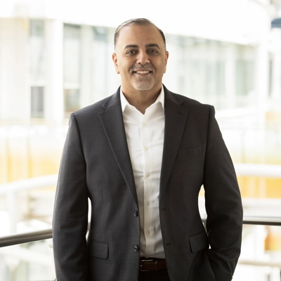 Man in suit standing in front of balcony