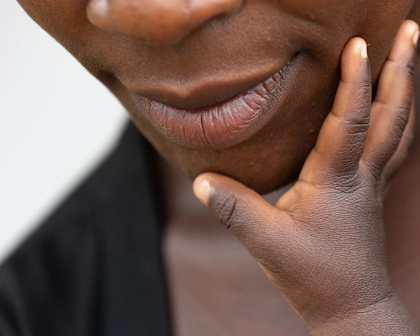baby touching mothers face