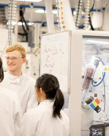 Scientists conversing over skeletal formulae