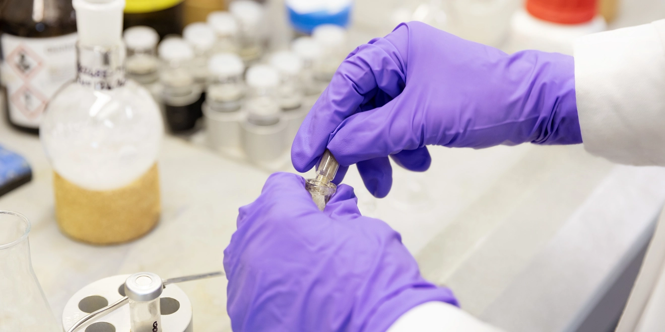 Scientist in the lab with globes on