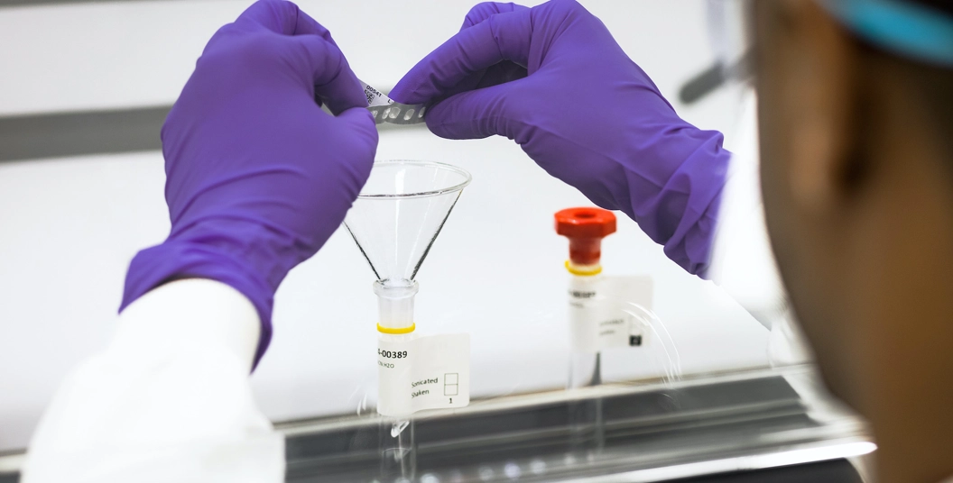 GSK quality lab operator engaged in focussed task.