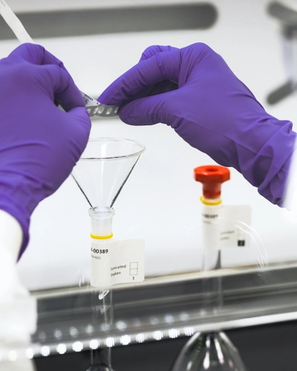 GSK quality lab operator engaged in focussed task.