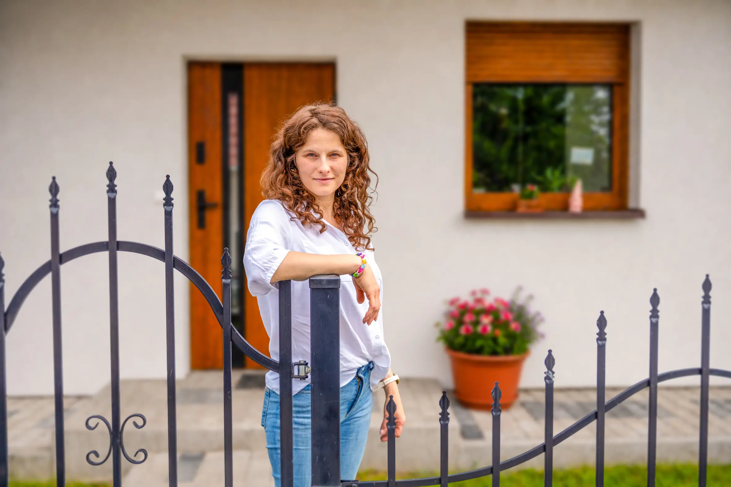Natalia standing at her gate