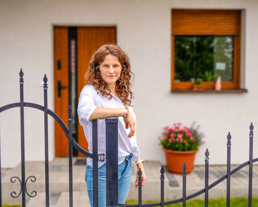Natalia standing at her gate