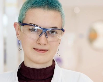 Woman in labcoat smiling
